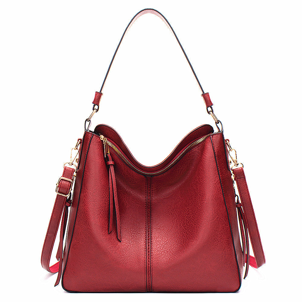 Red handbag with gold accents on a white backgroundshop_this_look_AVdw3f